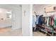 Walk-in closet with ample hanging and shelving space for shoes and clothes at 6764 Mary Loop, The Villages, FL 34762