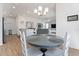 Open concept dining room with a view into the living room and kitchen areas at 6764 Mary Loop, The Villages, FL 34762