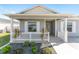 White porch with gray house siding and landscaping at 6764 Mary Loop, The Villages, FL 34762