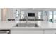Kitchen island with double sink and view into living room at 6764 Mary Loop, The Villages, FL 34762