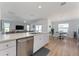 Open concept kitchen with stainless steel dishwasher and view into dining area at 6764 Mary Loop, The Villages, FL 34762