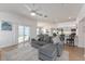 Living area with gray sectional sofa and access to backyard at 6764 Mary Loop, The Villages, FL 34762
