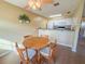 Small dining area with round wooden table and four chairs at 723 Perkins St # 203, Leesburg, FL 34748