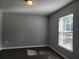 Neutral bedroom with dark floors, a window with blinds, and plenty of natural light at 8101 Sw 128Th Loop, Ocala, FL 34473