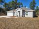 Inviting single-story home showcasing a well-maintained lawn and attached two-car garage at 8101 Sw 128Th Loop, Ocala, FL 34473