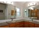 Double vanity bathroom with granite countertops at 9059 Se 177Th Grassmere St, The Villages, FL 32162