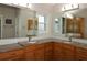 Double vanity bathroom with granite countertops at 9059 Se 177Th Grassmere St, The Villages, FL 32162