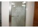 Bathroom with shower featuring etched glass door and grab bar at 9059 Se 177Th Grassmere St, The Villages, FL 32162