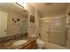 Bathroom with granite countertop, walk-in shower, and toilet at 9059 Se 177Th Grassmere St, The Villages, FL 32162