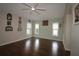 Spacious bedroom with hardwood floors, ceiling fan, and multiple windows at 9059 Se 177Th Grassmere St, The Villages, FL 32162