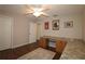Bedroom with hardwood floors, ceiling fan, and built-in desk at 9059 Se 177Th Grassmere St, The Villages, FL 32162