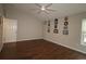 Bright bedroom with hardwood floors and a door at 9059 Se 177Th Grassmere St, The Villages, FL 32162