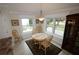 Breakfast nook with wood table and chairs, overlooking backyard at 9059 Se 177Th Grassmere St, The Villages, FL 32162