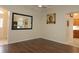 Bright dining room with dark hardwood floors and mirror at 9059 Se 177Th Grassmere St, The Villages, FL 32162