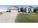 Spacious home with a three-car garage and landscaping at 9059 Se 177Th Grassmere St, The Villages, FL 32162