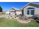 House exterior with landscaped yard and fountain at 9059 Se 177Th Grassmere St, The Villages, FL 32162