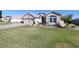 Landscaped front yard with paver driveway and fountain at 9059 Se 177Th Grassmere St, The Villages, FL 32162