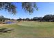 Landscaped golf course with pond and trees at 9059 Se 177Th Grassmere St, The Villages, FL 32162