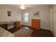 Home office with wood desk, built-in cabinets, and wood flooring at 9059 Se 177Th Grassmere St, The Villages, FL 32162