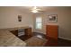 Home office with wood desk, built-in cabinets, and wood flooring at 9059 Se 177Th Grassmere St, The Villages, FL 32162