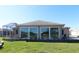 Rear view of house showcasing large windows and patio at 9059 Se 177Th Grassmere St, The Villages, FL 32162