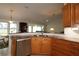 Kitchen with island, granite countertops, and wood cabinets at 9059 Se 177Th Grassmere St, The Villages, FL 32162