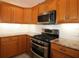Kitchen with stainless steel appliances and granite countertops at 9059 Se 177Th Grassmere St, The Villages, FL 32162