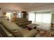 Living room with leather sofas and access to sunroom at 9059 Se 177Th Grassmere St, The Villages, FL 32162
