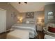 Main bedroom with king-size bed, sitting area, and vaulted ceiling at 9059 Se 177Th Grassmere St, The Villages, FL 32162