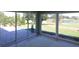Sunroom with large windows and view of patio and golf course at 9059 Se 177Th Grassmere St, The Villages, FL 32162