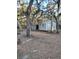 White building with a carport in a wooded area at 10094 Sw 153Rd Ln, Dunnellon, FL 34432