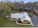 House with a metal roof, surrounded by trees at 10406 Lakeshore Dr, Clermont, FL 34711