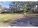Large backyard with grassy area and brick patio at 10406 Lakeshore Dr, Clermont, FL 34711