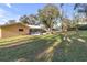 Large backyard with patio, providing ample outdoor space at 10406 Lakeshore Dr, Clermont, FL 34711