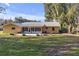 House exterior and spacious backyard with patio at 10406 Lakeshore Dr, Clermont, FL 34711