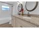 Updated bathroom with double vanity, granite countertop and marble tile at 10406 Lakeshore Dr, Clermont, FL 34711