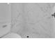 Updated bathroom with marble-look shower and pebble floor at 10406 Lakeshore Dr, Clermont, FL 34711
