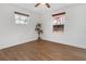 Spacious bedroom with wood-look floors and dual windows at 10406 Lakeshore Dr, Clermont, FL 34711
