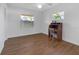 Bright bedroom with wood-look floors and built-in desk at 10406 Lakeshore Dr, Clermont, FL 34711
