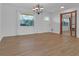 Dining room with wood floors and view into kitchen at 10406 Lakeshore Dr, Clermont, FL 34711