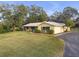 Ranch style home with metal roof, carport, and spacious yard at 10406 Lakeshore Dr, Clermont, FL 34711