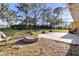 Stone fire pit and patio in the backyard at 10406 Lakeshore Dr, Clermont, FL 34711