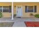 Front entry with white door and stylish landscaping at 10406 Lakeshore Dr, Clermont, FL 34711