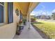 Covered porch with columns and potted plants at 10406 Lakeshore Dr, Clermont, FL 34711
