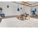 Spacious garage with hanging punching bag and riding mower at 10406 Lakeshore Dr, Clermont, FL 34711