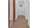 Clean and bright hallway with wood-look floors and neutral walls at 10406 Lakeshore Dr, Clermont, FL 34711