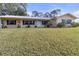 Single-story home with metal roof and landscaping at 10406 Lakeshore Dr, Clermont, FL 34711