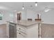 Kitchen island with wine cooler and granite countertop at 10406 Lakeshore Dr, Clermont, FL 34711