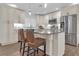 Updated kitchen with island, stainless steel appliances, and white cabinets at 10406 Lakeshore Dr, Clermont, FL 34711