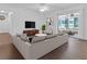 Living room with sectional sofa and access to screened porch at 10406 Lakeshore Dr, Clermont, FL 34711